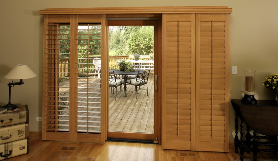Wood bypass patio door shutters in New Brunswick living room